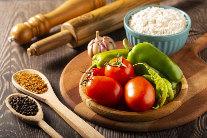 Wooden table with ingredients for pizza.