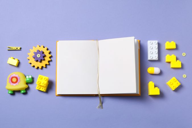 Children's book, with toys, on a purple background.