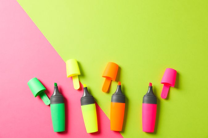 Open highlighters on two tone background, space for text