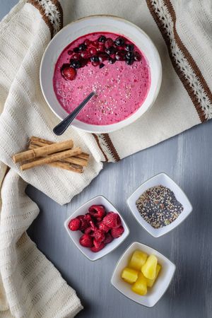 Smoothie bowl with fresh berries and sesame served on table