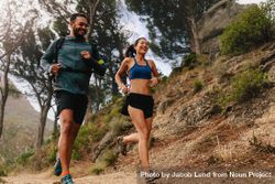 Man and woman jogging on country path bG2Ba4