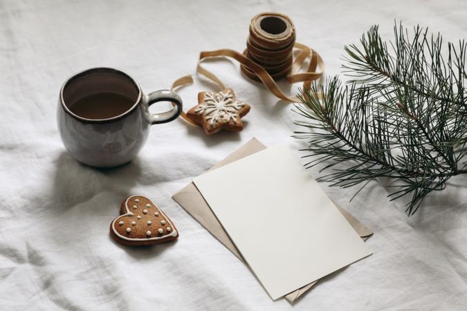 Moody Christmas stationery surrounded with branches, coffee and gingerbread cookies