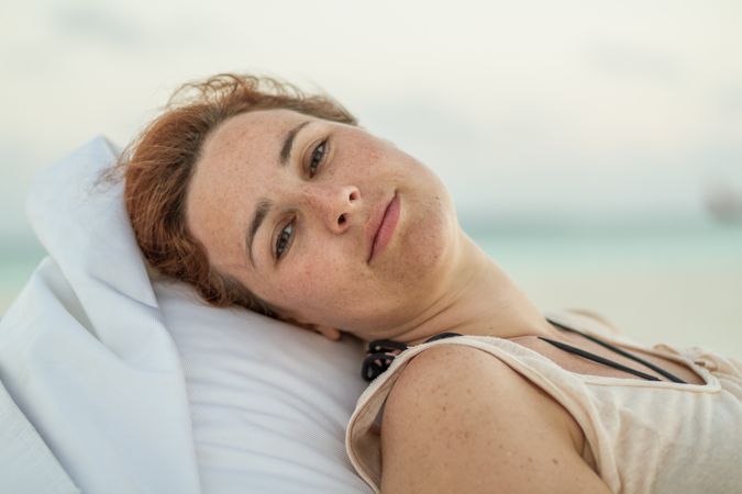 Woman in sunglasses resting on resort