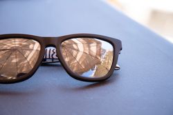 Sunglasses reflecting umbrellas