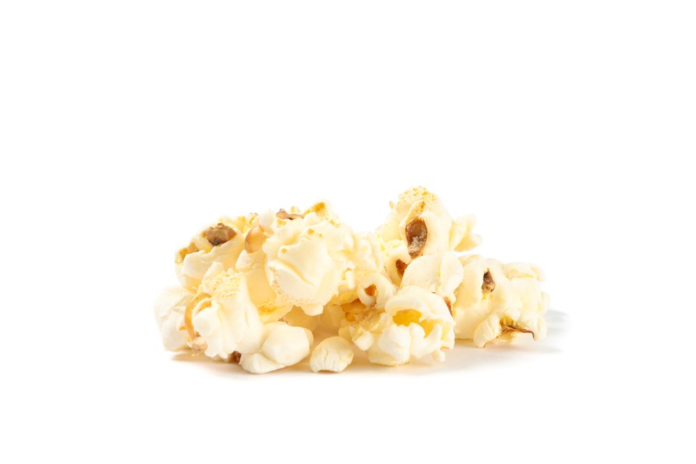 Popcorn pile isolated on blank background, close up