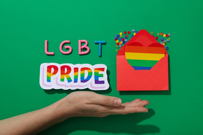 LGBT parade concept, envelope on green background.