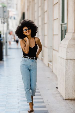 Cheerful Black female in dark sunglasses