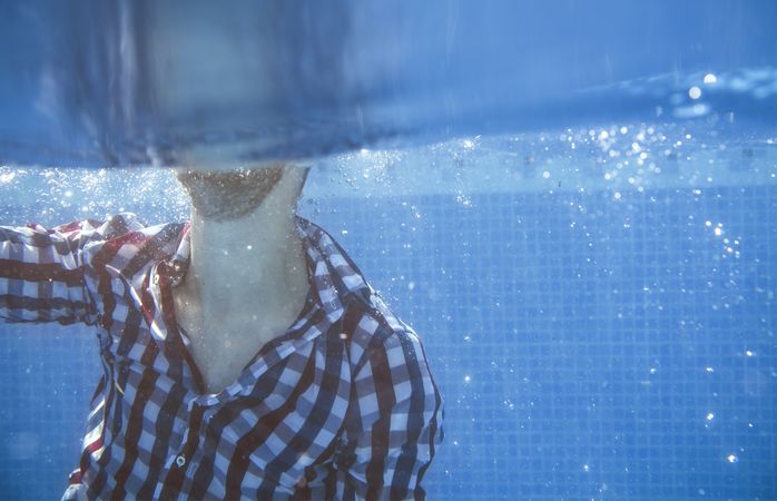 Dressed man in swimming pool