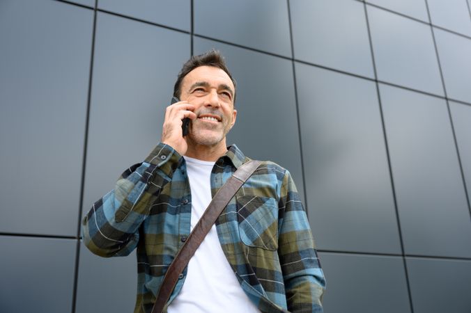 Cheerful young man talking on smartphone
