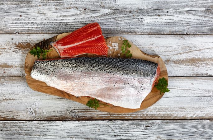 Rainbow trout fillets on olive wood board for cooking