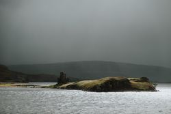 Small island near coast of Scotland on stormy day