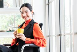 Happy and calm woman in a bright office