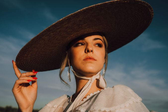 woman in hats in bright sunny day