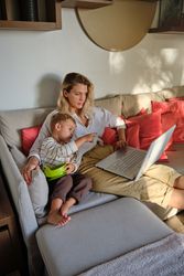 Mother and son watching film on laptop together