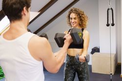 Man and woman lifting dumbbells