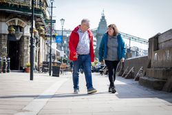 Older man and woman walking outside
