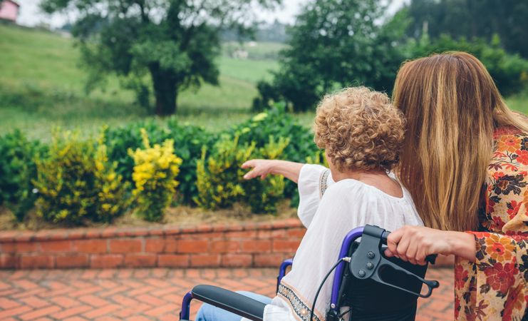 Older woman in a wheelchair with her daughter