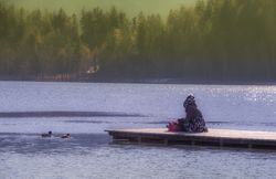Young woman sitting on Lake Bleds pier