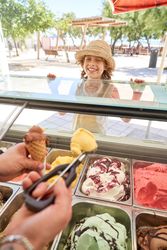Smiling child waiting for ice cream in park