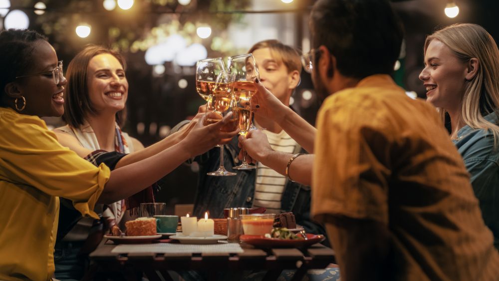 Toasting and Clinking Glasses with Wine and Champagne, Celebrating Their Reunion