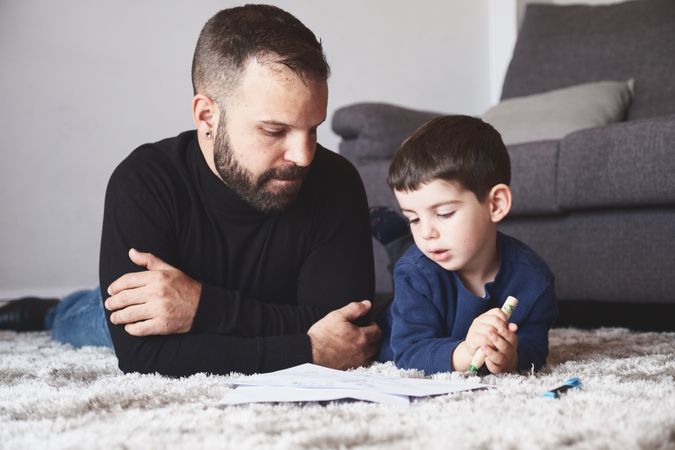 Father and son drawing on floor