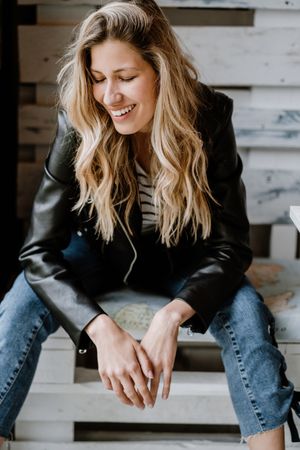 Woman sitting in a wooden bench in cafe