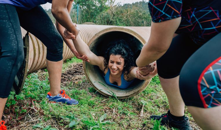 Participants obstacle course going through a pipe