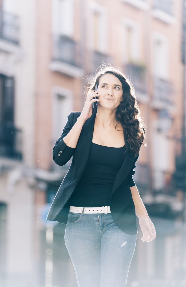 Young female walking with smartphone