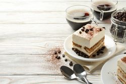 Composition with tasty tiramisu on wooden background. Delicious dessert