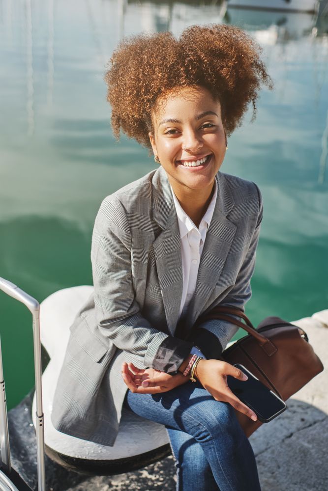 Black woman in smart casual outfit in port