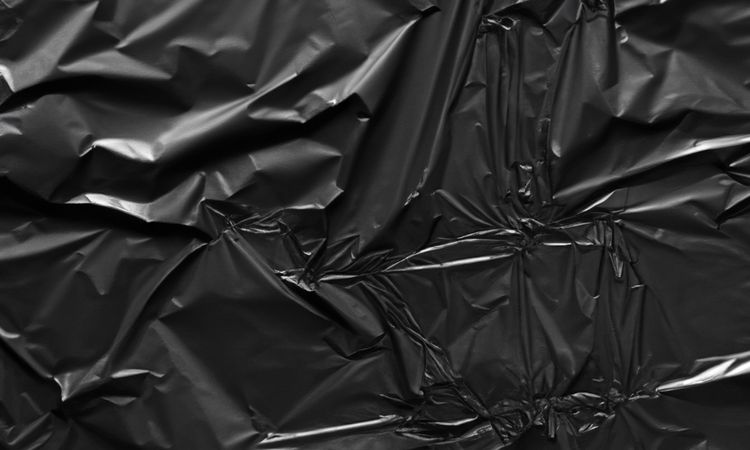 dark crumpled and creased plastic poster texture background