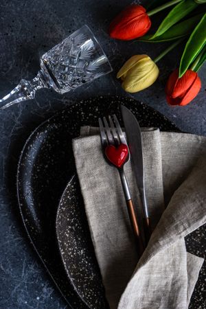 Top view of table setting with heart ornament and crystal glass