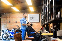 Barber talking to his bearded male client