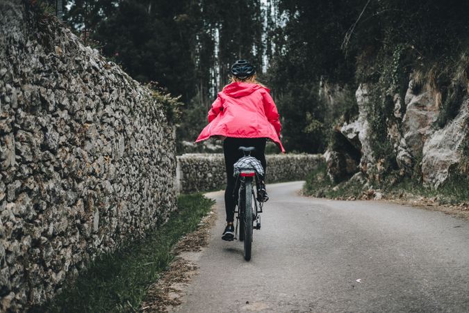 Female riding bicycle in countryside road