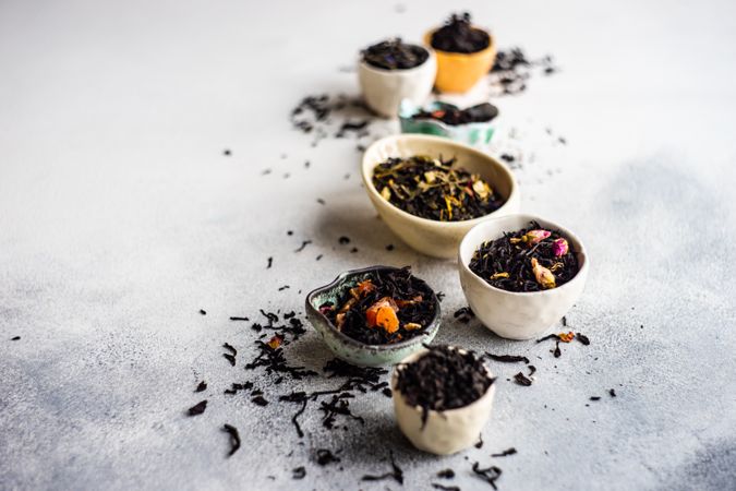 Bowls of loose leaf tea on marble counter