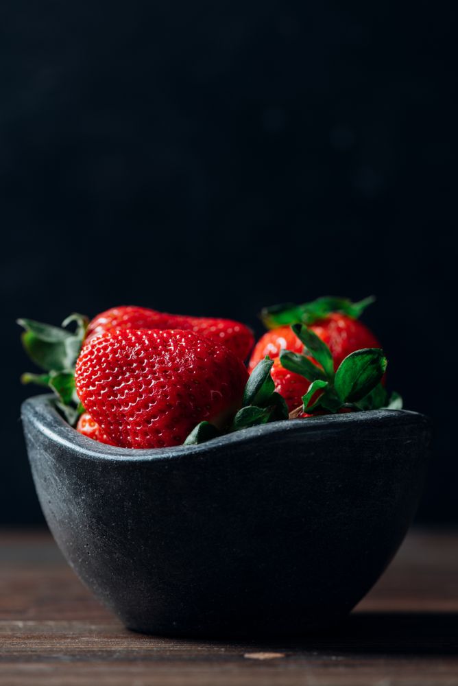 Fresh ripe strawberries in concrete bowl