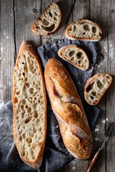 Fresh baguettes on checkered towel