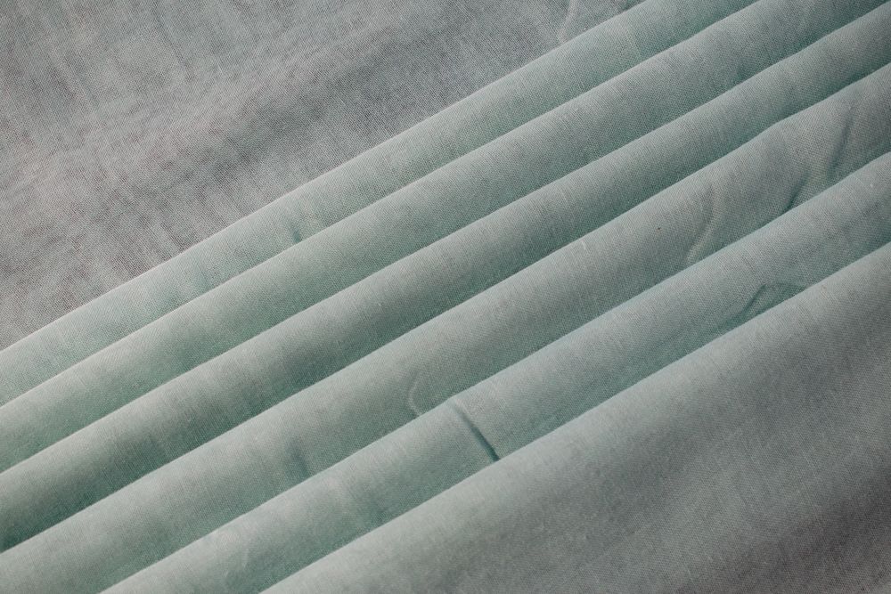 Nude green fabric folded background texture