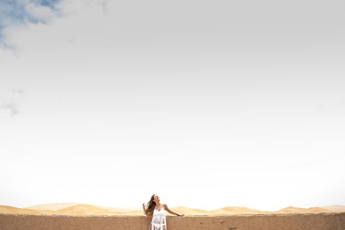 Woman on terrace against desert landscape