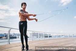 Athletic Black male working out on the water front with a jumprope 423Qqb