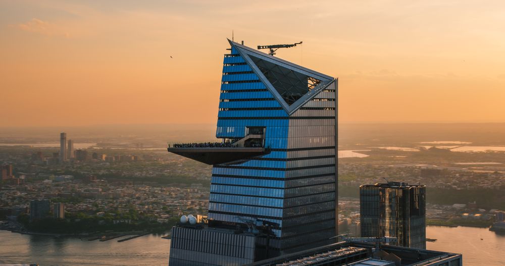 Panorama Around the 30 Hudson Yards Skyscraper in New York City, USA. Aerial Photo with a Modern Skyscraper with Crowded Observation Balcony. Travelers Relishing the Panoramic Summer View