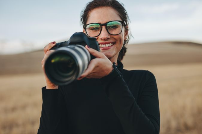 Female photographer working at outdoor location with dslr