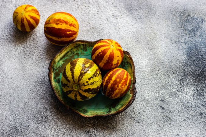 Organic mini melons on grey counter with copy space