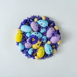 Easter eggs and purple flowers and leaves