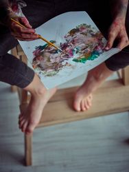 Faceless kid painting on paper