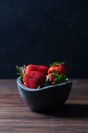 Fresh ripe strawberries in concrete bowl