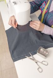 Seamstress hands working on a sewing machine