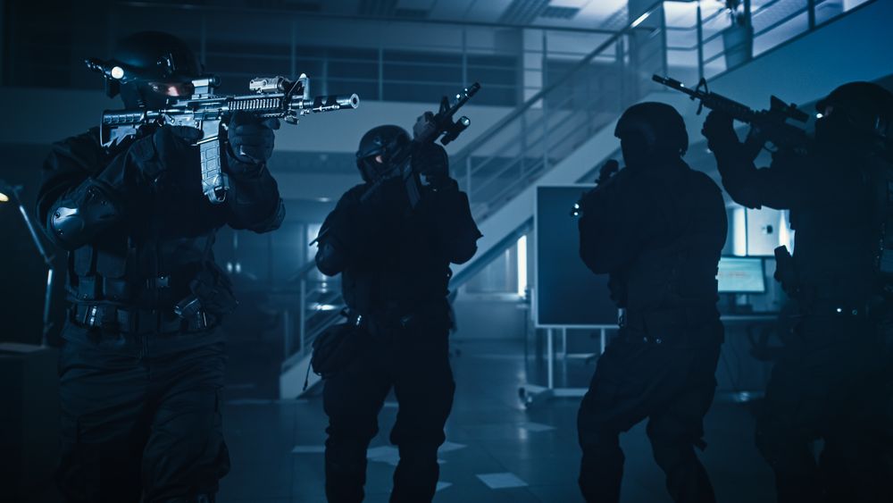 Soldiers with Rifles and Flashlights Move Forward and Cover Surroundings.