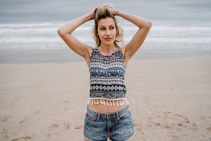 Happy female posing on sandy beach