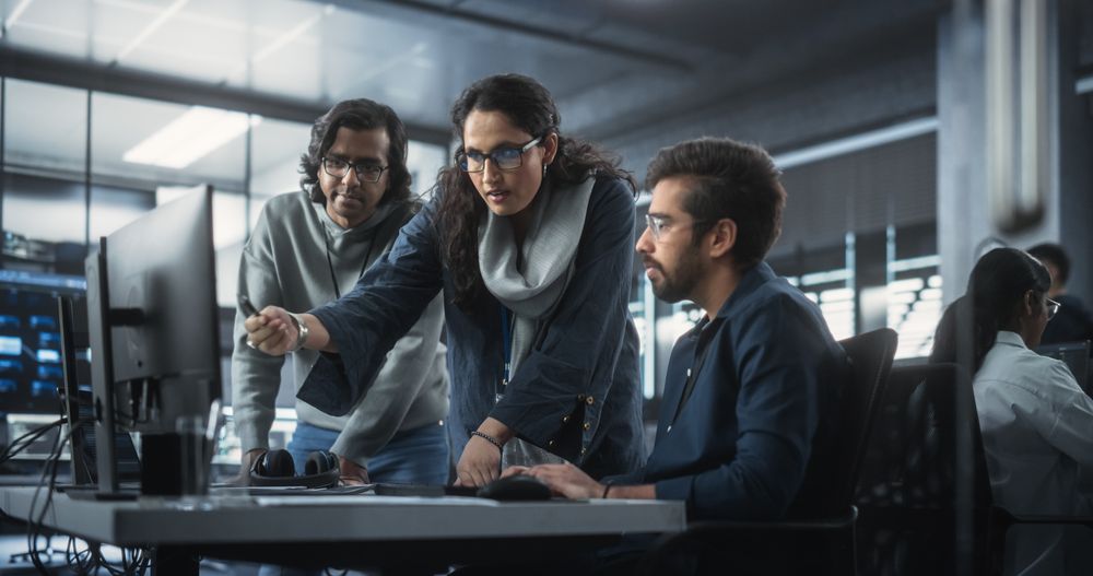 Team of Three Diverse South Asian Software Developers Talk, Discuss a Technological Project.